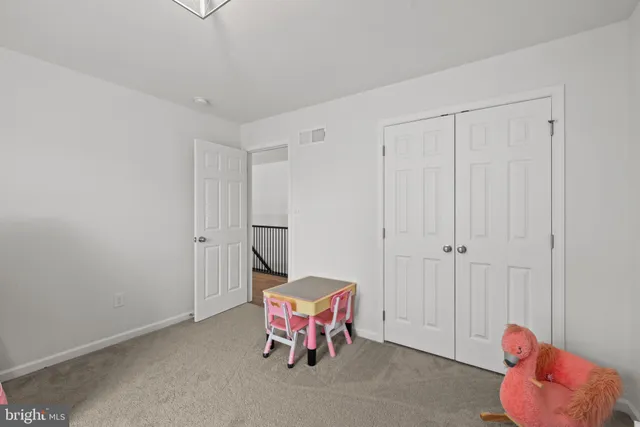 a hallway with toys and a couch