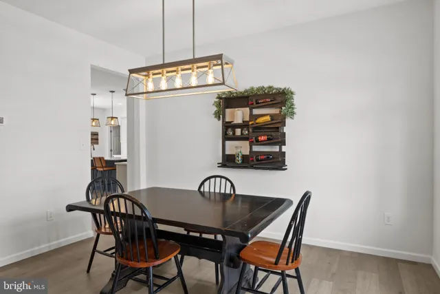 a view of a dining room with furniture and front door