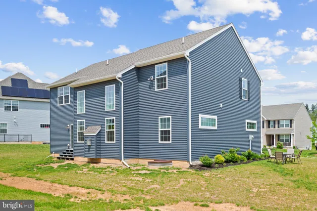 a backyard of a house with yard and outdoor seating