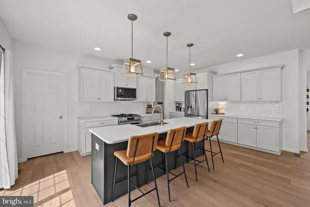 a large kitchen with a table and chairs