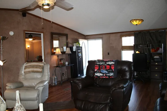 a living room with furniture and a wooden floor