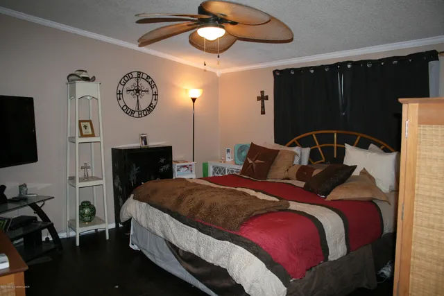 a bedroom with a bed and a chandelier