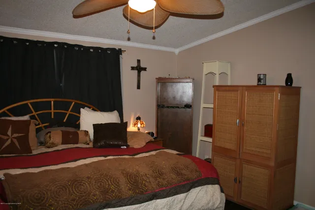 a bedroom with a bed and a mirror