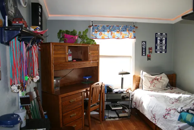 a bedroom with a bed table and a window