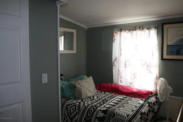 a bed sitting in a bedroom next to a window