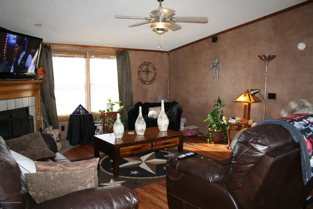 a living room with furniture gym equipment and a flat screen tv