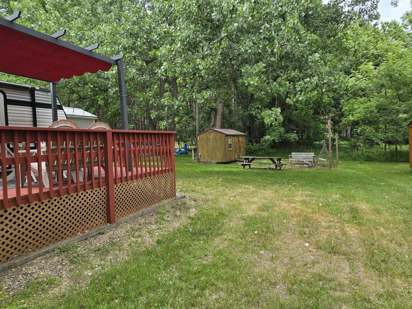 17-249 Woodhaven Sublette, IL 61367 - Photo 3 of 14 a view of a deck with a table and chairs under an umbrella