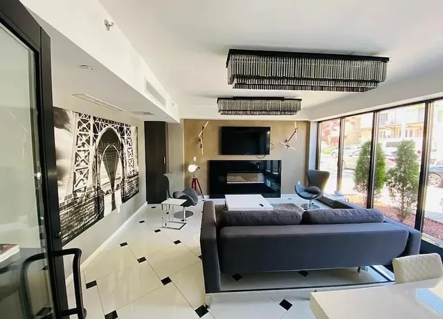 a living room with furniture fireplace and flat screen tv