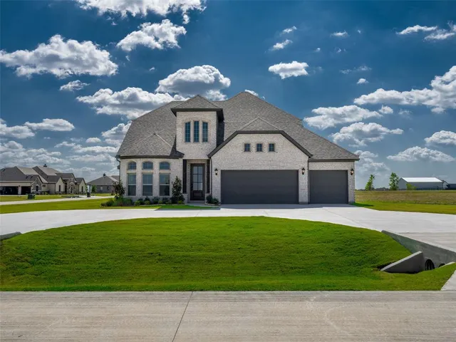 a front view of a house with a big yard