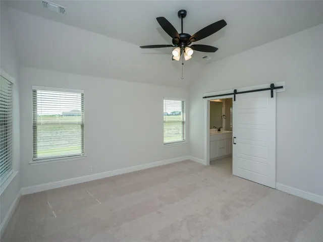 a view of a livingroom with a ceiling fan and window