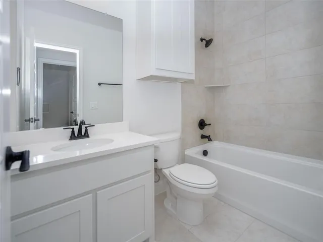 a bathroom with a sink a toilet and a bathtub