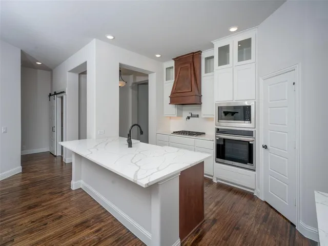 a kitchen with stainless steel appliances a sink and a refrigerator