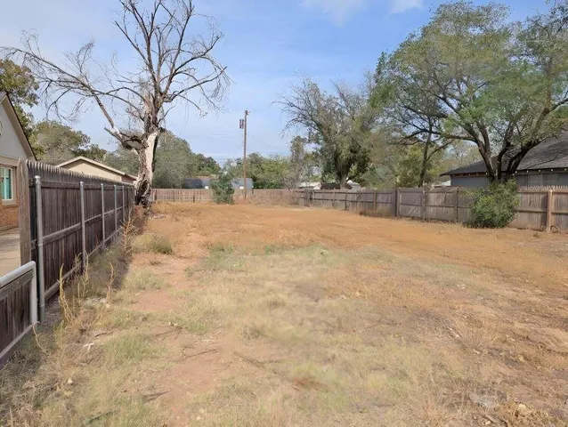 a view of a yard with snow on the road