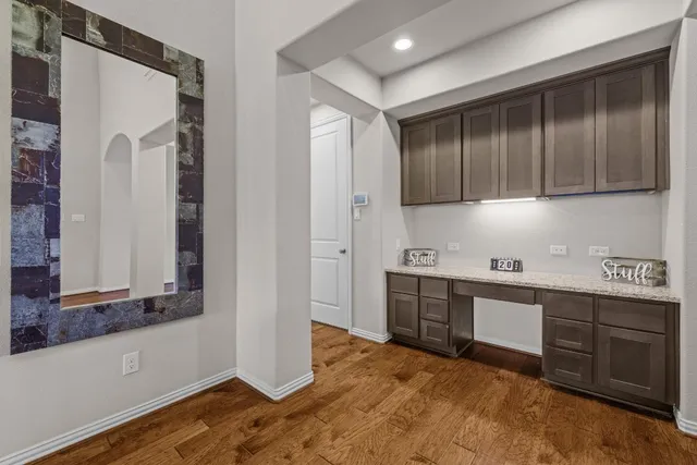 a kitchen with stainless steel appliances granite countertop wooden cabinets a sink and a stove