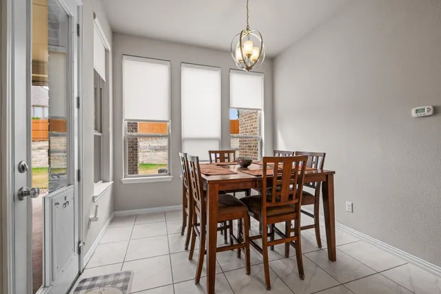 a large kitchen with granite countertop a large counter top a sink stainless steel appliances and cabinets