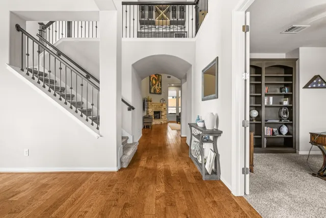 a view of entryway and hall with wooden floor