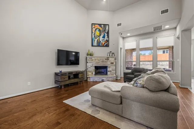 a living room with fireplace furniture and a flat screen tv
