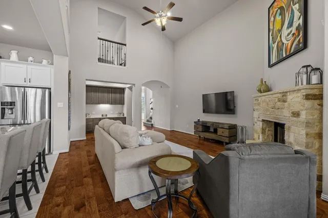 a living room with furniture a fireplace and a flat screen tv