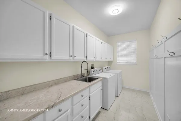 a kitchen with sink and cabinets