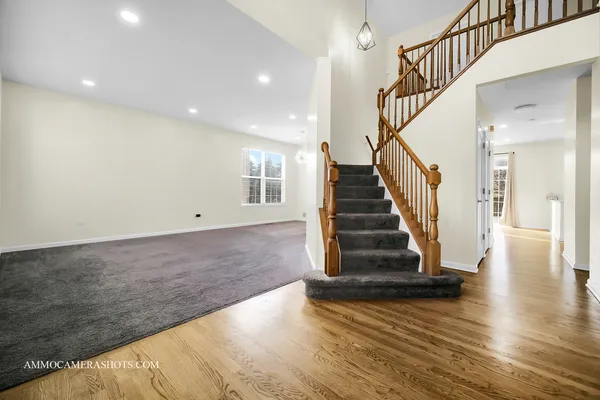 a view of entryway and hall with wooden floor