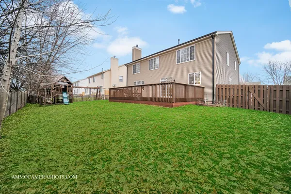 a view of a house with a yard and sitting area