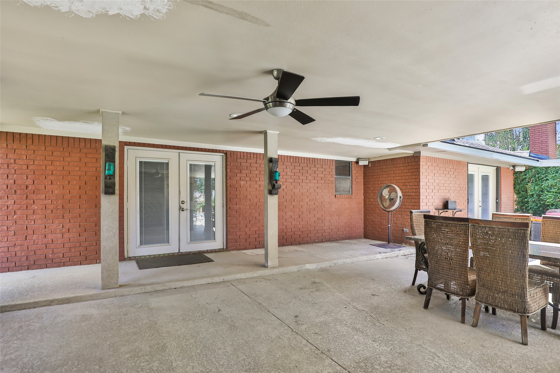 1300 Smith Road Huffman, TX 77336 - Photo 10 of 50 French doors lead to a stylish outdoor kitchen, perfect for entertaining.