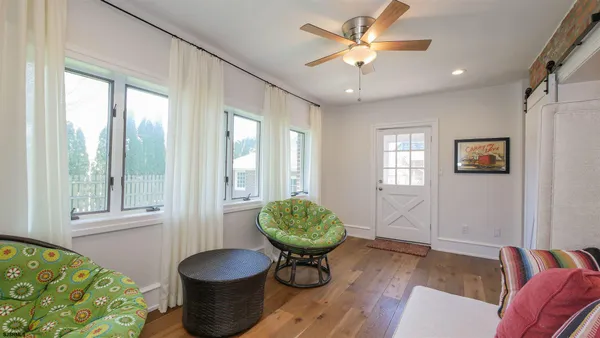 a living room with a couch and a chandelier