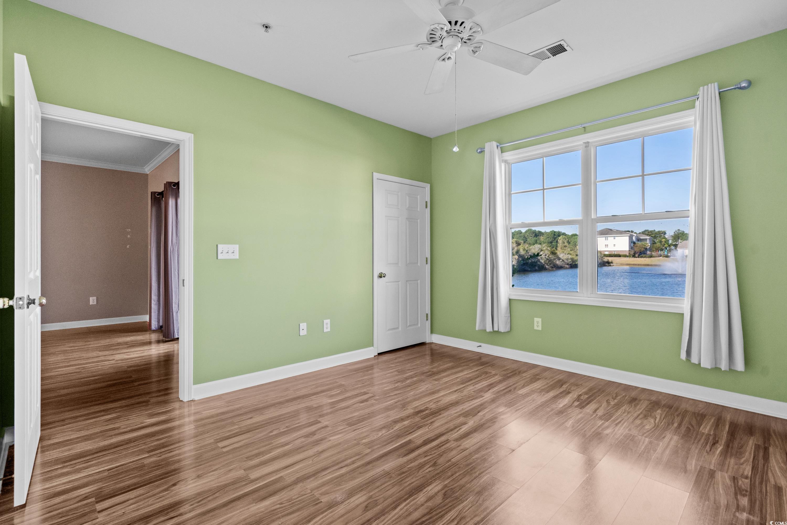336 Kiskadee Loop, Unit B Conway, SC 29526 - Photo 23 of 40 Unfurnished room with a water view, ceiling fan, ornamental molding, and hardwood / wood-style floors