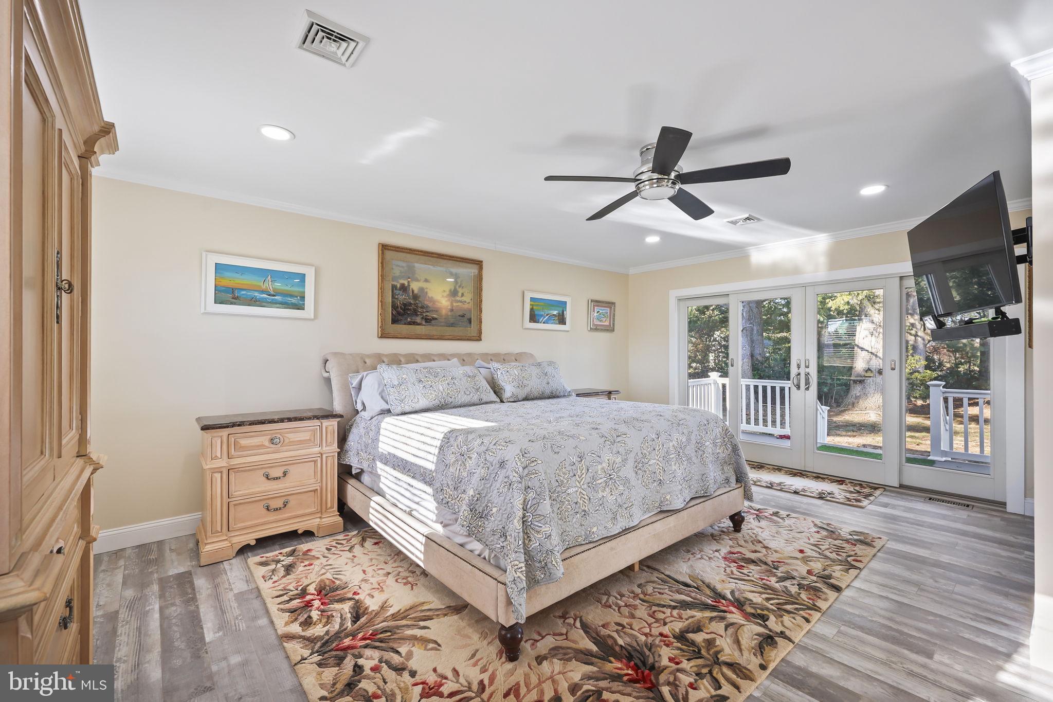 568 Village Road East Princeton Junction, NJ 08550 - Photo 25 of 43 a spacious bedroom with a large bed a flat tv screen and a dresser