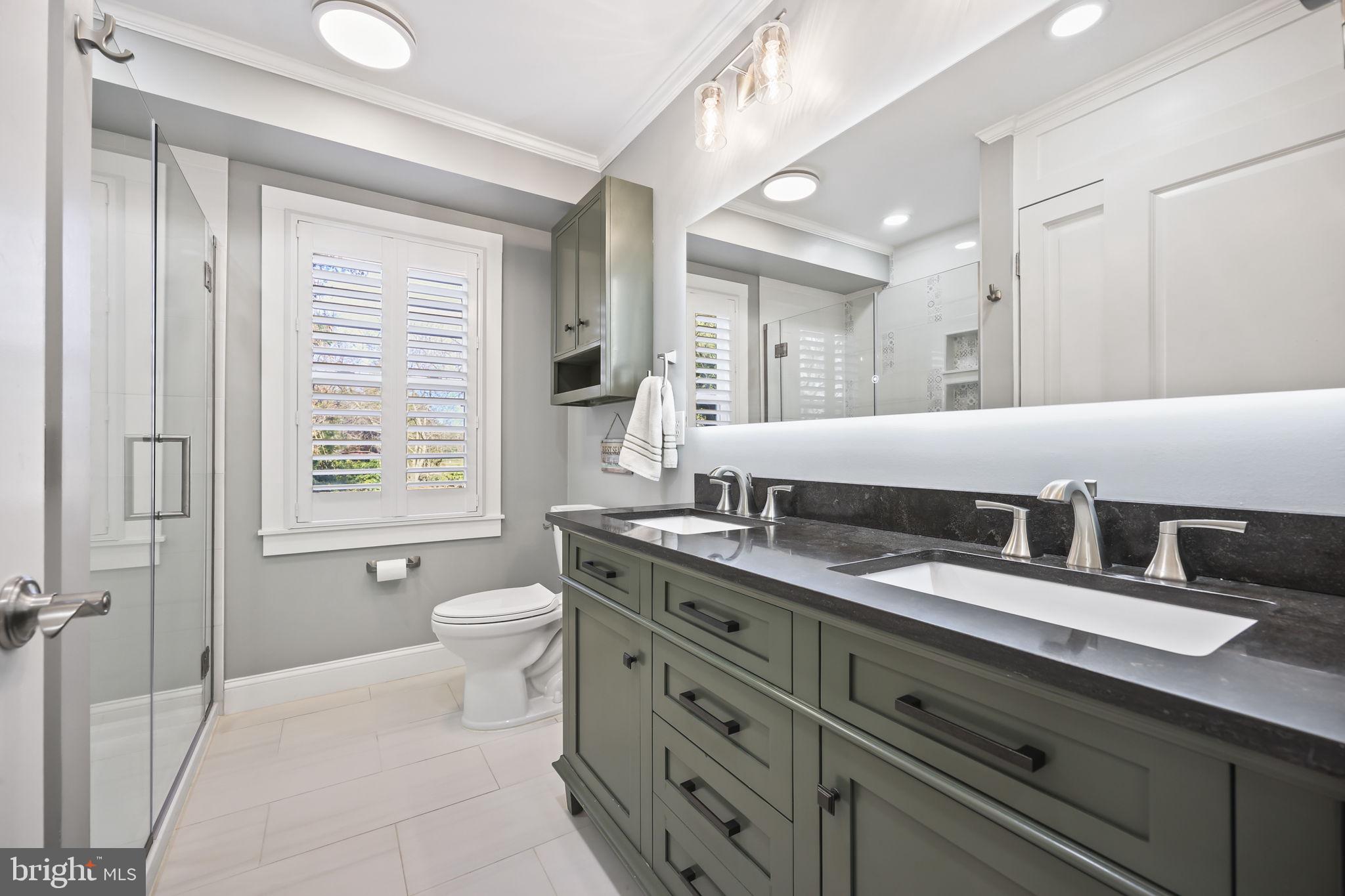 568 Village Road East Princeton Junction, NJ 08550 - Photo 26 of 43 a bathroom with a granite countertop double vanity sink a mirror and a bathtub