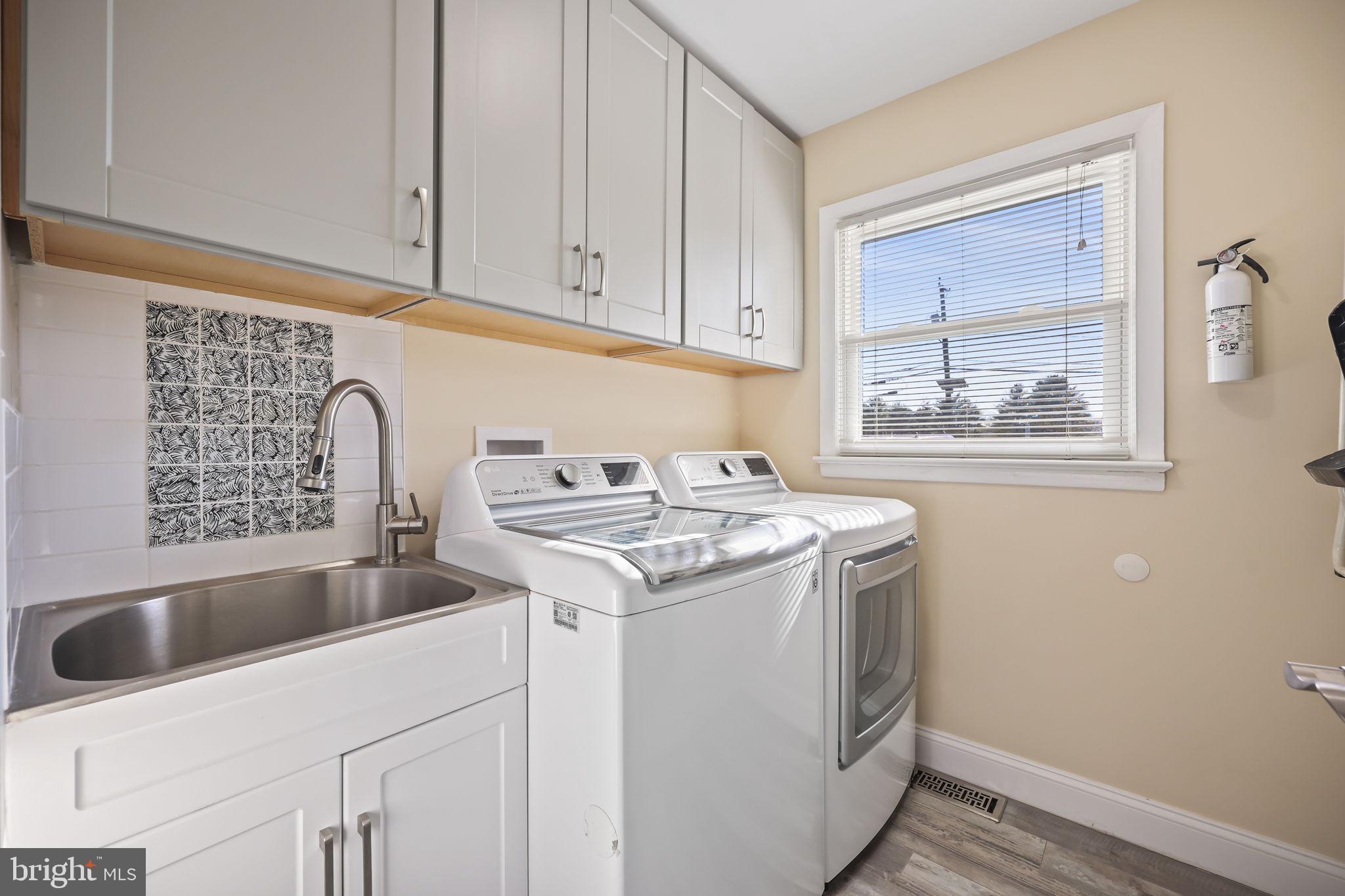 568 Village Road East Princeton Junction, NJ 08550 - Photo 36 of 43 a utility room with sink dryer and washer