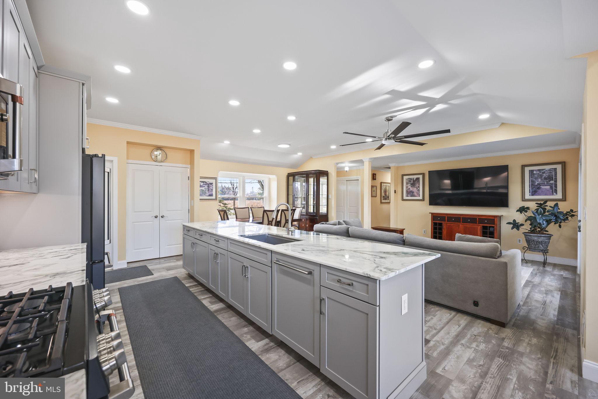 568 Village Road East Princeton Junction, NJ 08550 - Photo 8 of 43 a large kitchen with kitchen island a large counter top appliances and cabinets