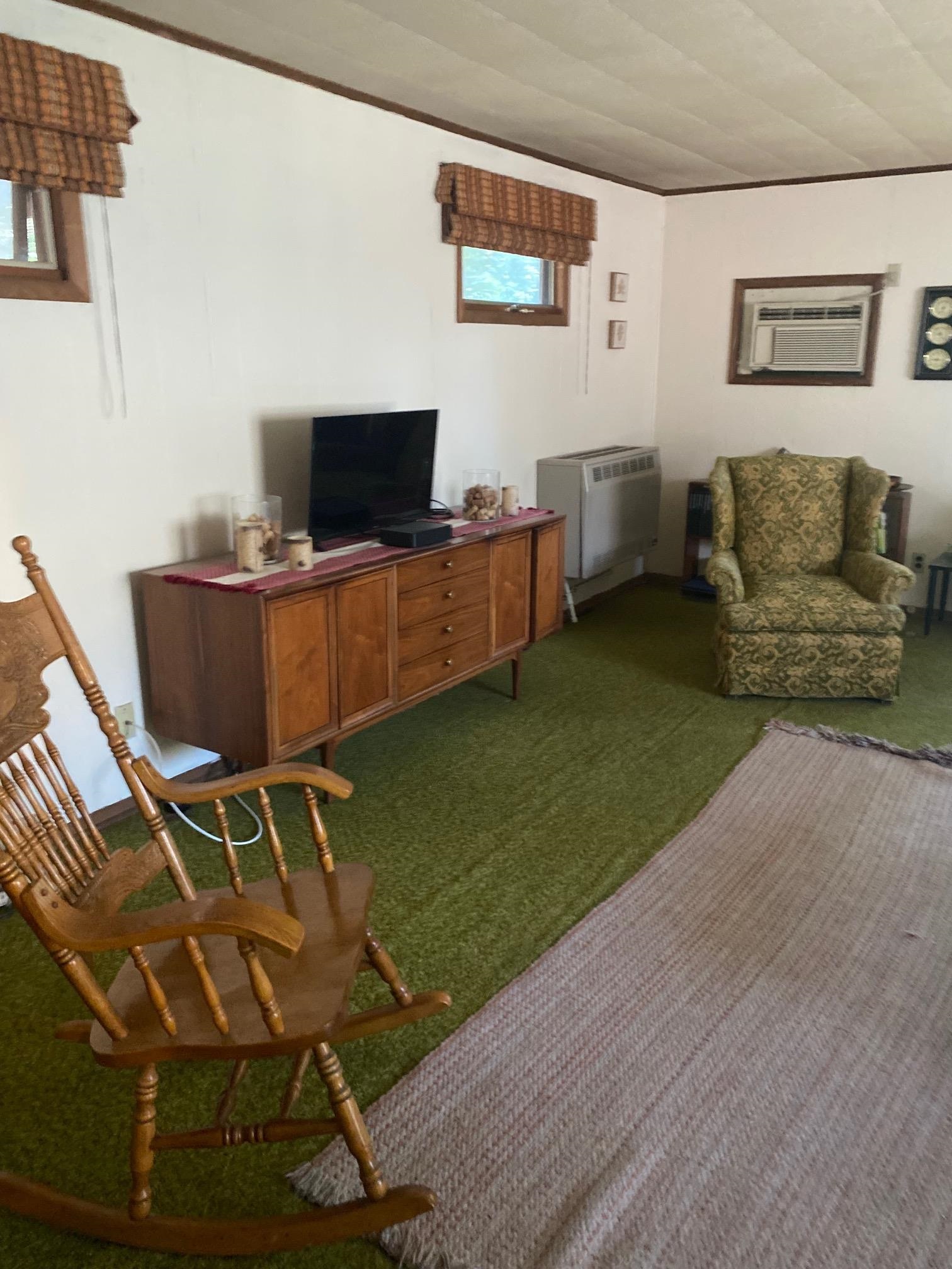 4619 Highcrest Road Rockford, IL 61107 - Photo 3 of 9 a living room with furniture and a flat screen tv
