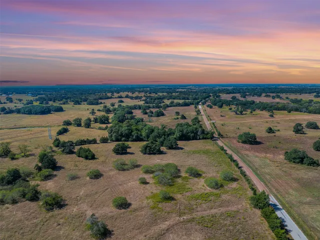 a view of a lake with beach and city view