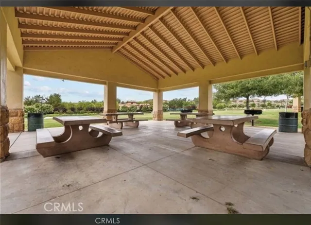 a living room with patio furniture and a floor to ceiling window