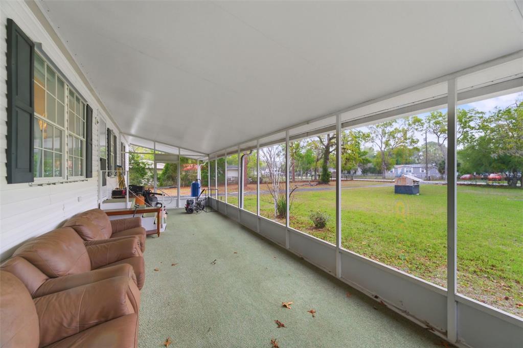 9634 Pat Street Hudson, FL 34669 - Photo 11 of 73 a living room with couch and a floor to ceiling window