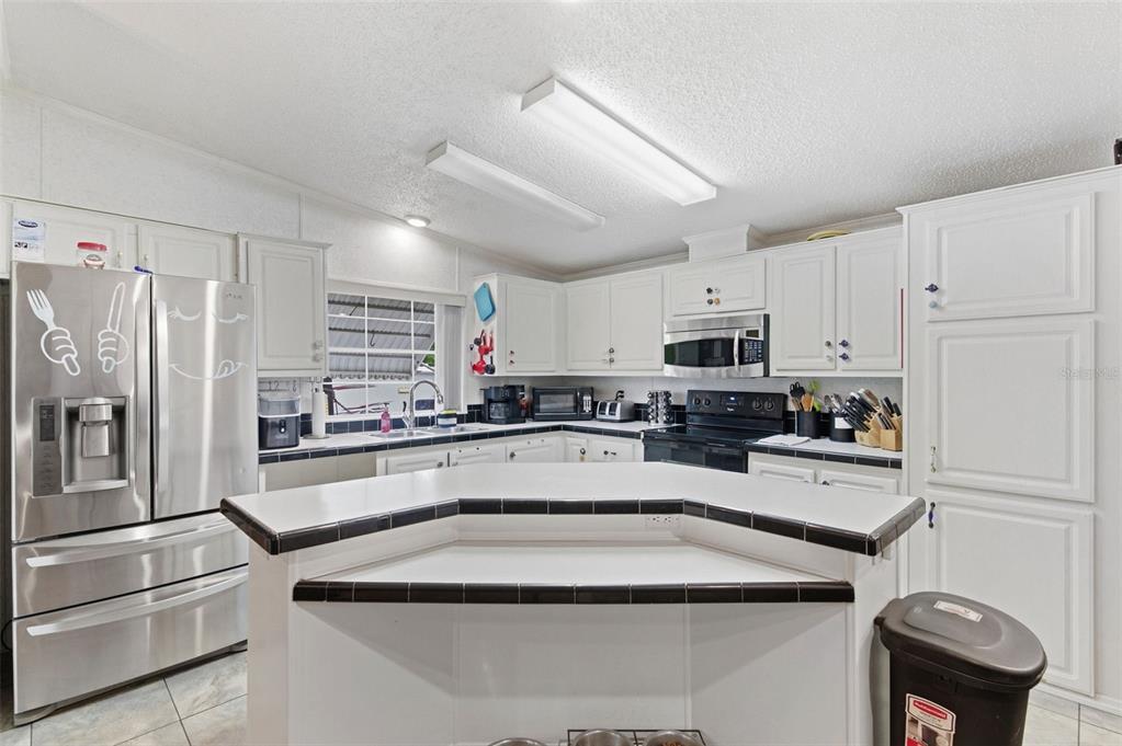 9634 Pat Street Hudson, FL 34669 - Photo 12 of 73 a kitchen with stainless steel appliances granite countertop a refrigerator sink and stove