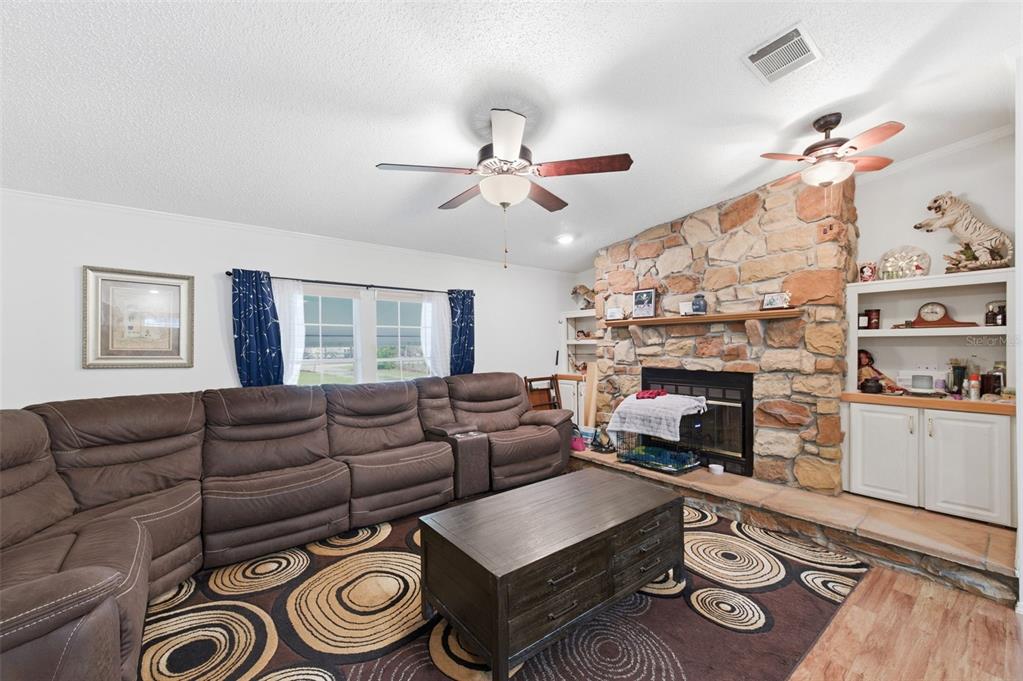 9634 Pat Street Hudson, FL 34669 - Photo 18 of 73 a living room with furniture a fireplace and wooden floor