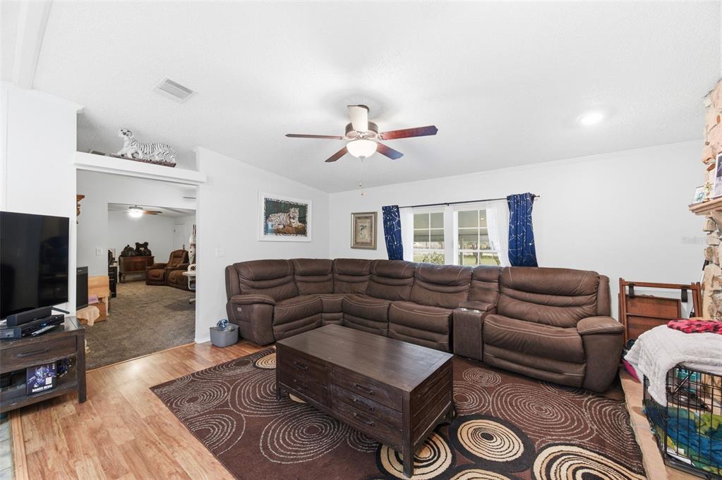 9634 Pat Street Hudson, FL 34669 - Photo 19 of 73 a living room with furniture and a flat screen tv