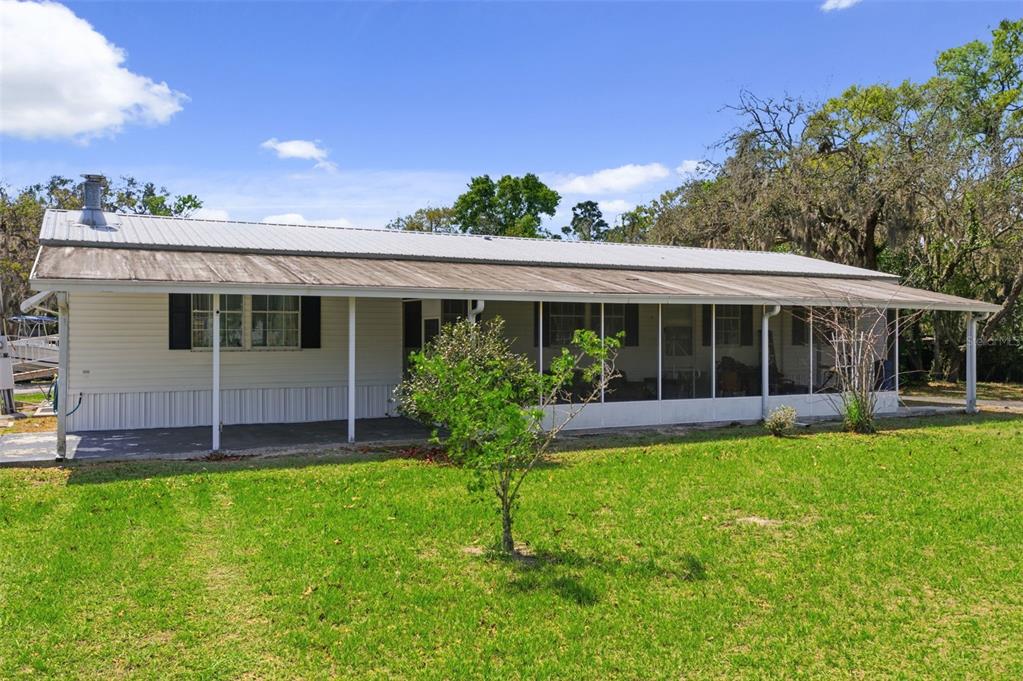9634 Pat Street Hudson, FL 34669 - Photo 2 of 73 a view of a house with a yard and sitting area