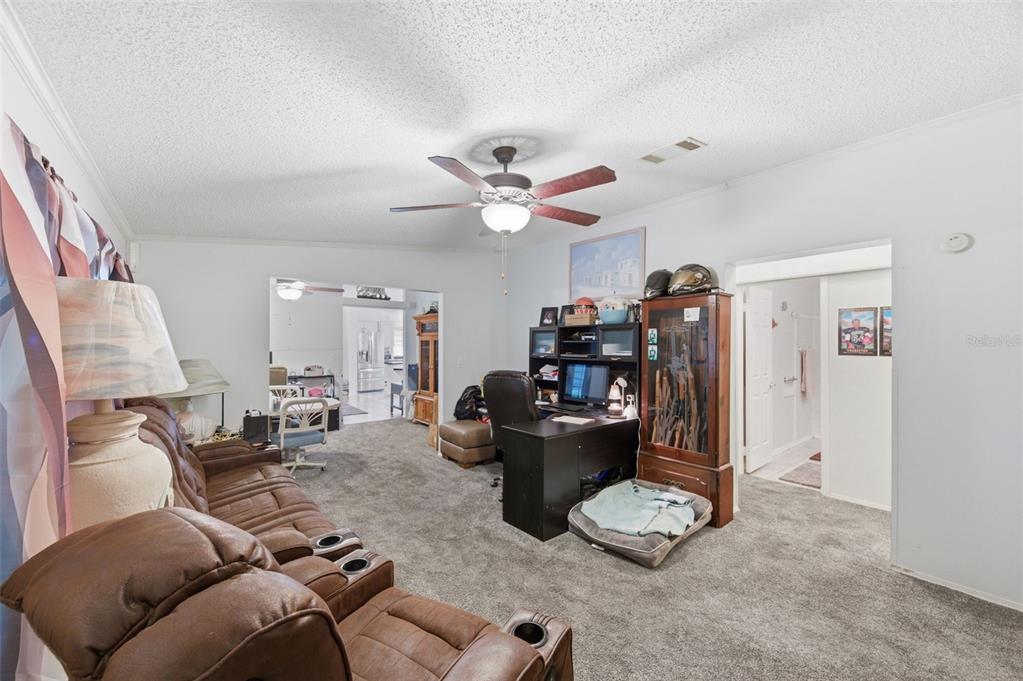 9634 Pat Street Hudson, FL 34669 - Photo 21 of 73 a living room with furniture and a ceiling fan