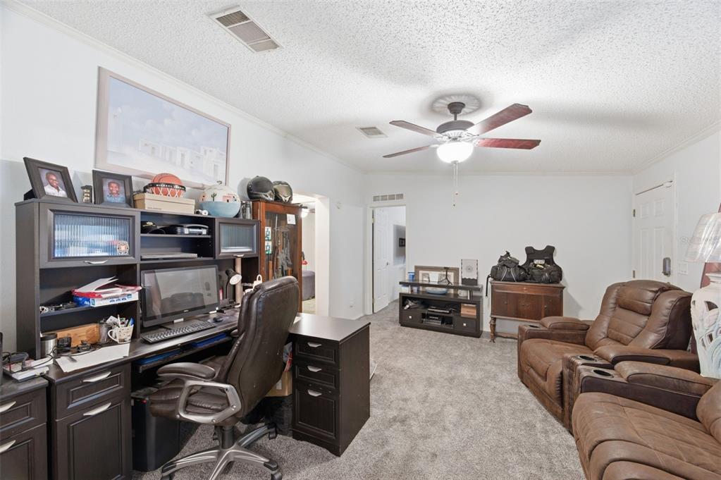 9634 Pat Street Hudson, FL 34669 - Photo 23 of 73 a living room with furniture and a ceiling fan