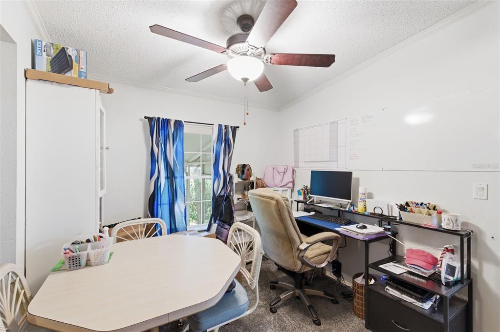 9634 Pat Street Hudson, FL 34669 - Photo 25 of 73 a view of a workspace with furniture and a flat screen tv