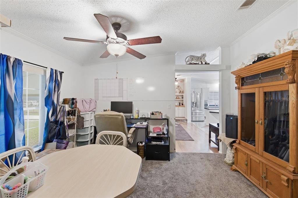 9634 Pat Street Hudson, FL 34669 - Photo 26 of 73 a living room with furniture a ceiling fan and a window