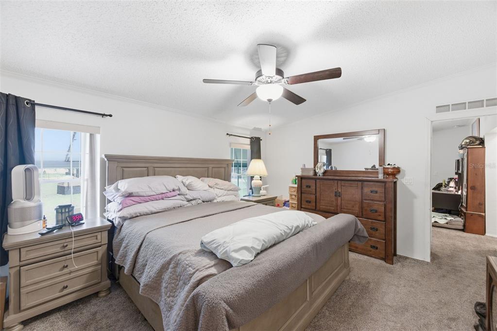 9634 Pat Street Hudson, FL 34669 - Photo 27 of 73 a bedroom with a bed and a chandelier