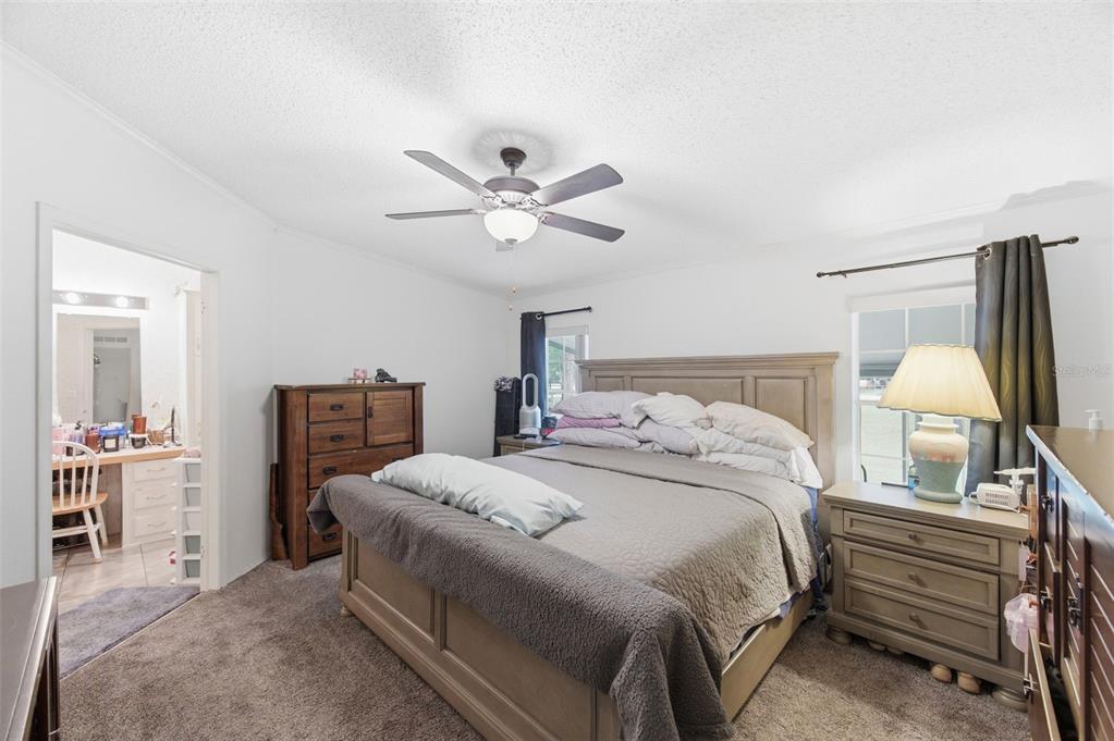 9634 Pat Street Hudson, FL 34669 - Photo 28 of 73 a bedroom with a bed and a chandelier