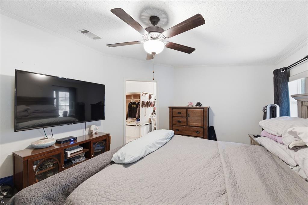 9634 Pat Street Hudson, FL 34669 - Photo 29 of 73 a bedroom with a bed and a flat screen tv with wooden floor