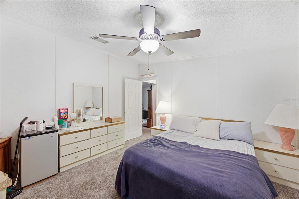 9634 Pat Street Hudson, FL 34669 - Photo 39 of 73 a bedroom with a bed and a chandelier