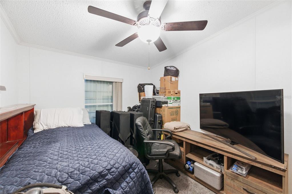 9634 Pat Street Hudson, FL 34669 - Photo 42 of 73 a bedroom with a bed and a flat screen tv