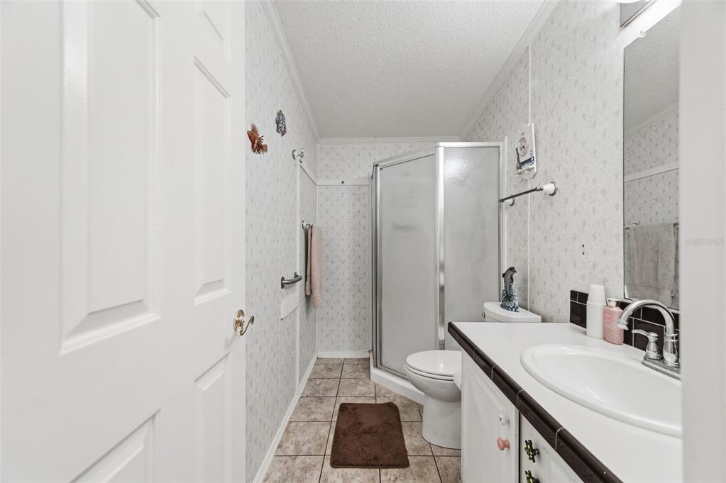 9634 Pat Street Hudson, FL 34669 - Photo 43 of 73 a bathroom with a sink a toilet and shower